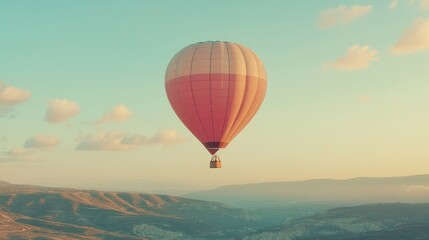 Fototapeta premium A pastel-hued hot air balloon floating gently above the countryside.