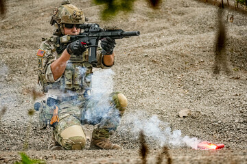 A group of military men in combat gear patrol in the middle of a desert and tropical jungle....