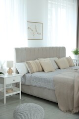 Big comfortable bed in room. Interior design