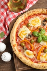 Delicious vegetarian pizza served on wooden table, flat lay