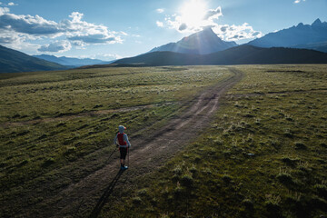 Aerial view of woman trail runner in high altitude mountains