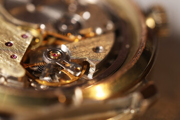 Mechanism of vintage wrist watch on light background, closeup