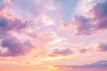 Soft pink clouds and yellow tones illuminate the morning sky at sunrise, creating a tranquil and beautiful natural canvas
