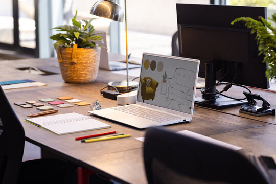 At office, Designing interior layout, laptop with sketches on desk, surrounded by color swatches - Powered by Adobe