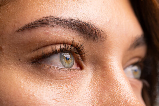 At office, Close-up of woman's green eyes and eyebrows, focusing on facial details