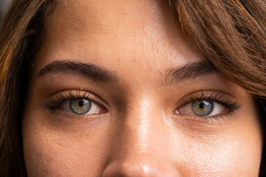 At office, Close-up of woman's eyes with green irises and natural makeup