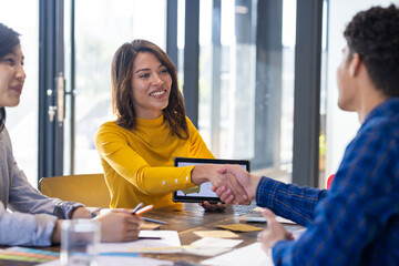 Shaking hands, woman with tablet making agreement with colleagues in office