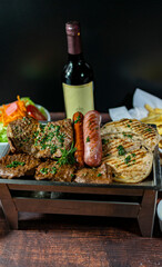 grilled chicken, beef, anticucho, pork chop, chorizo and hot dog, served with french fries, fresh salad and a bottle of wine.