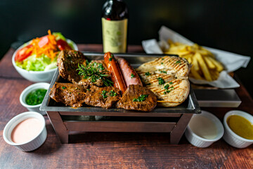 grilled chicken, beef, anticucho, pork chop, chorizo and hot dog, served with french fries, fresh salad and a bottle of wine.