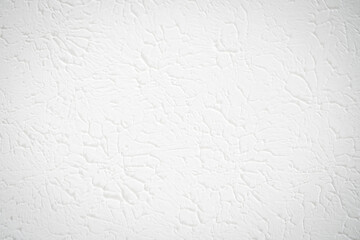 White textured wall or ceiling with plaster painted. Flat light texture with circular pattern and artistic impression.