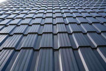 This is a detailed closeup view showcasing contemporary metal roofing tiles that feature a polished and shiny finish © Aleksey