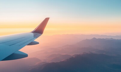 Obraz premium Airplane Wing and Sunset Over Mountain Range