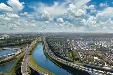 Aerial view of american freeway intersection with fast driving cars and trucks in Miami, Florida....