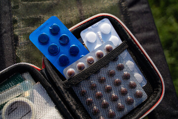 A wellequipped first aid kit is essential for emergencies, containing various pills, medications,...