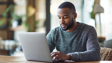 Black Man Working on Laptop in Coffee Shop