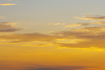 Beautiful sunset sky scenery. Bright colorful orange and yellow clouds on horizon