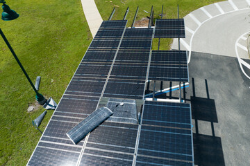 Damaged by hurricane wind photovoltaic solar panels mounted on parking lot canopy roof for...