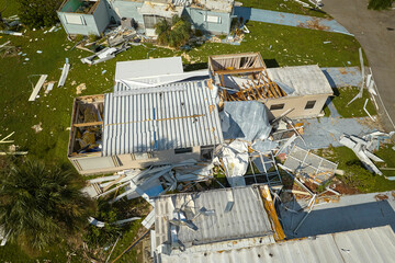 Destroyed by hurricane Ian suburban houses in Florida mobile home residential area. Consequences of...