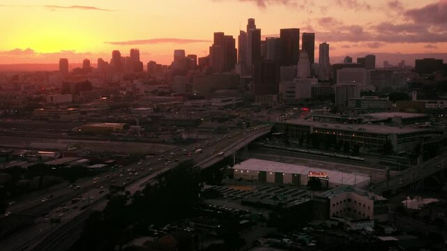 Aerial of Downtown Los Angeles Skyline Sunset over Highway 101 During Rush Hour 1
