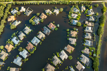 Flooded houses from hurricane rainfall water in Florida residential community. Aftermath of natural...