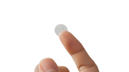 Finger holding contact lens on transparent background