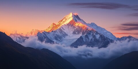 Snow-capped peaks glow under the light of sunrise, where the first rays of the sun cast a golden hue over the mountains
