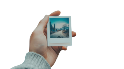 Hand holding instant photo card on transparent background