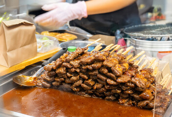 prepare barbecue pork or meat grill with sauce on plate for serve in street food in Thailand