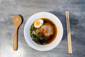 Homemade noodle Japanese style serve with wood chopstick and spoon on top view