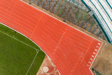 Aerial view of empty soccer field from above with running tracks around it Amazing stadium for many...