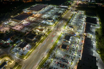 Traffic rush at shopping malls and small businesses in evening time in North Port, Florida. USA transportation and retail infrastructure concept