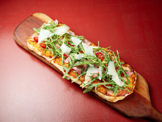 Arugula Jamon Pizza on a Cutting Board