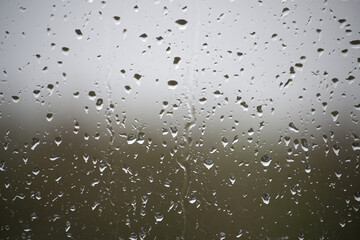 The raindrops on the window are small and numerous