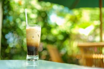 milk coffee and americano with a green forest background