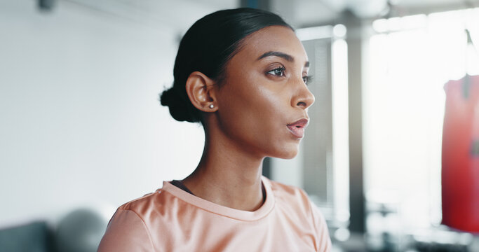 Woman, breathing and exercise with training at gym for fitness, indoor workout or wellness. Young, active or serious female person with vision for strength, endurance or determination at health club