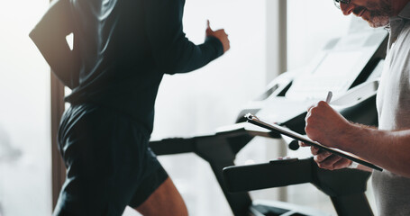 Man, running and treadmill with coach clipboard for cardio exercise, workout and training performance. Runner, instructor and machine for fitness advice , endurance or speed challenge of resilience