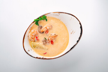 Tom Yam kung soup with shrimp and coconut milk. Traditional Thai-Asian spicy soup with seafood Tom Yam, top view