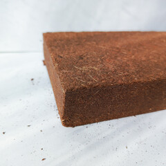 Coconut substrate for terrarium. Dry coconut substrate for snails. Filling the terrarium. Background. Coco peat. Substrate for growing plants, seedlings.