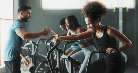 People, fitness coach and stationary bike at gym for exercise, training and workout with sweat....