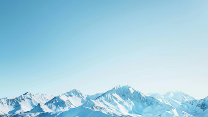 Snow-capped mountain peaks under clear blue sky with distant horizons