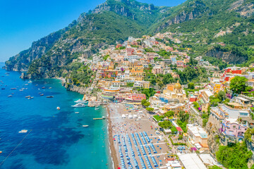Positano town, beach and beautiful colorful houses on the cliff in Amalfi coast in Italy