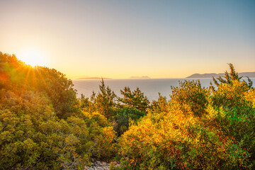 Lighthouse on the cliff. Seascape of Cape Lefkatas with old lighthouse on Lefkada island, Greece. Beautiful views of azure sea water and nature with cliffs
