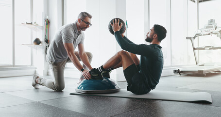 Fototapeta na wymiar Personal trainer, fitness and medicine ball in gym with training, exercise and wellness coaching. Professional, support and core workout with abs, gear and athlete at health and sport club together