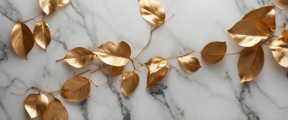 Fototapeta premium A white marble background with gold leaves on it.