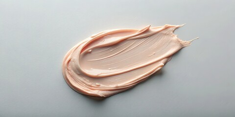 Creamy gel balm cosmetic texture smudged on a soft pastel gray background