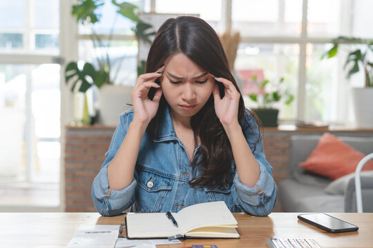stressed woman accounting home expenses and calculate credit card monthly debt to bills payment.