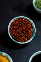 Traditional oriental spices in ceramic bowls. black cumin seed, ground red pepper, dried mint, himalayan ​​salt.