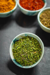 Traditional oriental spices in ceramic bowls. black cumin seed, ground red pepper, dried mint, himalayan ​​salt.