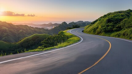 Naklejka premium A winding road through lush green hills at sunset, offering a tranquil and scenic view for travelers and nature enthusiasts.