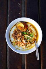 Chicken porridge from top view. Potrait size. White bowl.